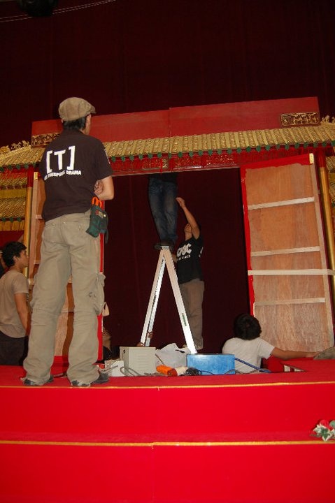 A group of four people assembling an ornate stage