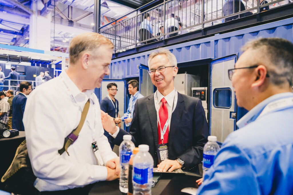 Professional networking at the MHI-ESA award-winning two-storey innovation booth at Data Centre World Asia 2025