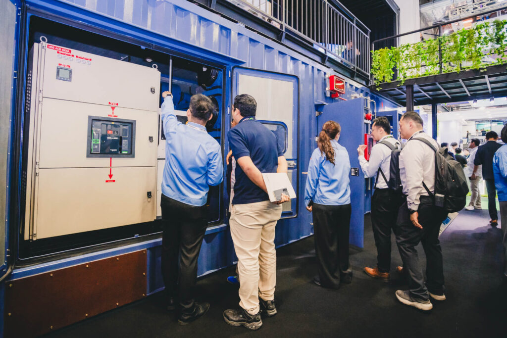 MHI-ESA staff members providing a technical demonstration of the MGS2500R containerized generator at a trade show
