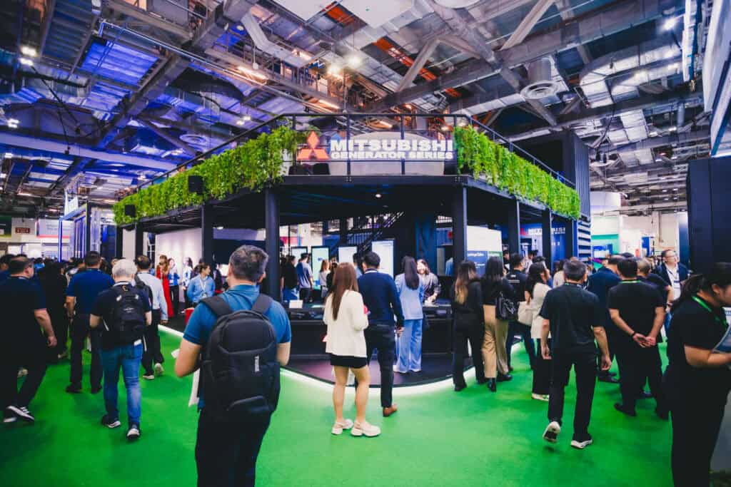 A large crowd of visitors explores the Mitsubishi Heavy Industries two-storey innovation booth at Data Centre World Asia.