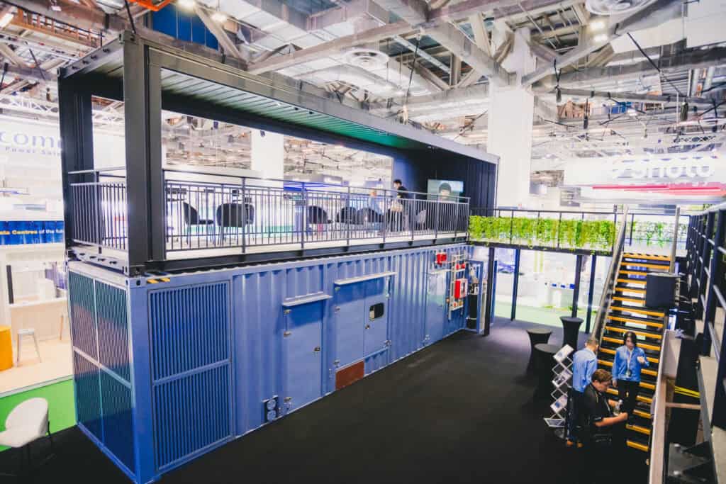 Mitsubishi Heavy Industries' two-storey innovation booth featuring the MGS2500R containerized generator at a Singapore trade show