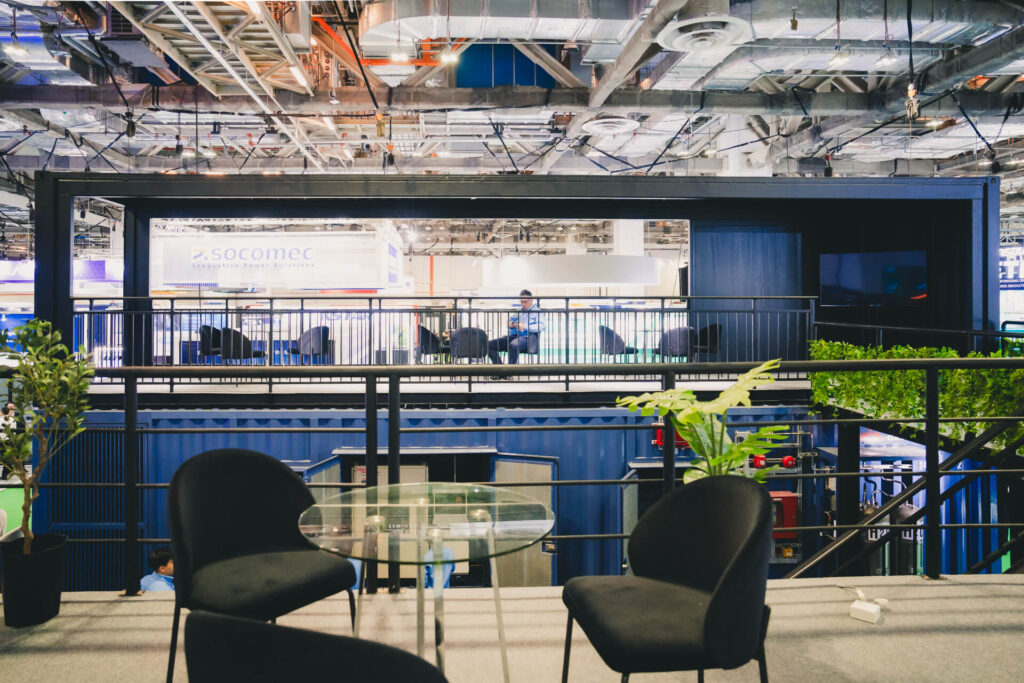 The modern upper-deck VIP lounge of the Mitsubishi Heavy Industries innovation booth at a trade show.